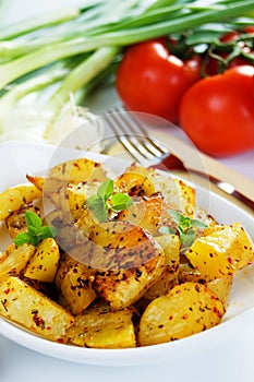 Well spiced roasted potato slices photo