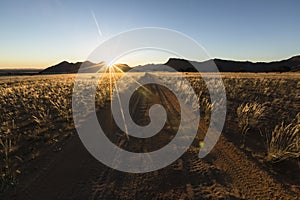 Well used, Dusty desert road to nowhere. Southern Namibia. Mountain scenery surrounding. S