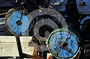 well-used and strikingly coloured mechanical fishing gear on a traditional wooden Greek fishing boat.