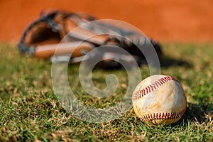 Well worn baseball on grass field