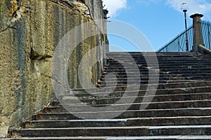 Well worn Sandstone stairs against blue sky.