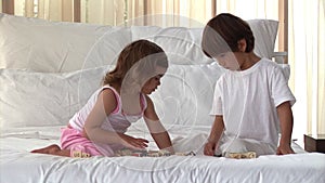 Wellbehaved children playing on the bed