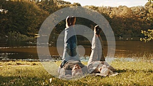 Wellbeing concept. Portrait of happy senior retired couple meditating in autumn park