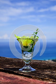 wellcome drink : Cold water and yellow flower in clear glass on blue sky background photo