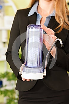 Welldressed woman holding modern faucet container