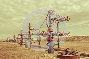 Wellheads with valve armature on a oil field.