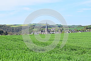 Welling, Germany - 05 09 2021: Village Welling behind green grain fields