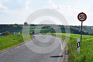 Welling, Germany - 05 09 2022: limit 50 kph in front of the curve leading into the village