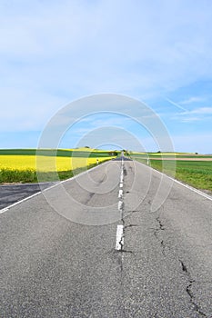 Welling, Germany - 05 09 2021: straight road through spring landscape with many road damages photo