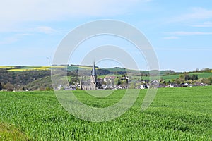 Welling, Germany - 05 09 2021: Village Welling in the valley behind green grain fields photo