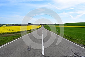 Welling, Germany - 05 09 2021: badly crackes road through spring landscape in the Eifel photo
