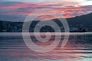 Wellington, New Zealand, colorful sunset over calm harbor.