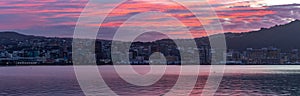 Wellington, New Zealand, Panorama colorful sunset over calm harbor.