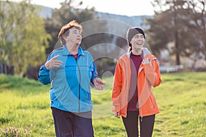 Wellness and activity. Happy grandmother and granddaughter walking together in the spring park. Familytime. Outdoor