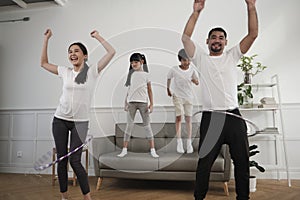 The wellness Asian Thai family is fun playing hula hoops together