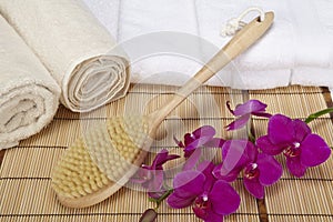 Wellness - Bath brush, rolled towels and orchids