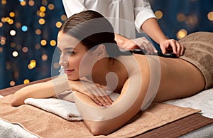 beautiful woman having hot stone massage at spa