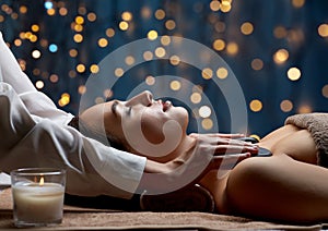 close up of woman having hot stone massage at spa