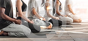 Wellness Concept. Side View Of Diverse People Meditating Together During Yoga Class