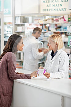 Wellness, health and happy pharmacy customer at store counter for medicine expertise with smile. Pharmaceutical advice