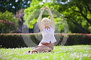 Wellness. Mental Health. Optimistic Old Woman Exercising in Open Air