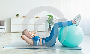 Smiling Sporty Woman Exercising With Ball At Home