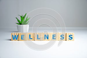 Wellness sign with wooden cubes and flowers