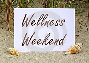 Wellness Weekend sign on beach