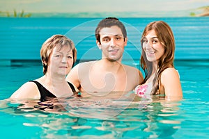 Wellness - woman and couple in swimming pool