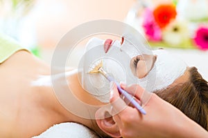 Wellness - woman getting face mask in spa