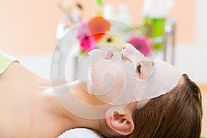 Wellness - woman getting face mask in spa