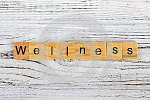 WELLNESS word made with wooden blocks concept