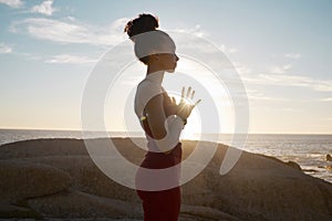 Wellness, yoga and meditation with black woman and fitness at the beach, calm and peace in the sun with lens flare. Zen