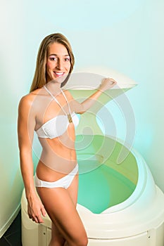 Wellness - young woman floating in Spa in bathtub