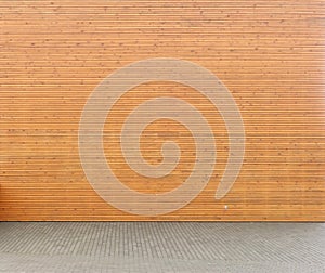 Wellow wooden wall from horizontal planks and  yard from concrete tiles  panorama