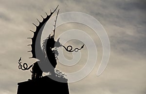 Welsh Dragon statue in Silhouette, against a wintry sky