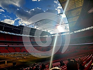 Wembley Stadium with sunlight on empty seats