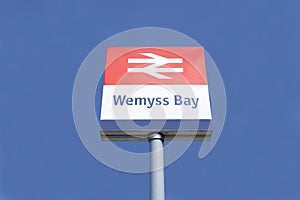Wemyss Bay railway train station sign against blue sky background