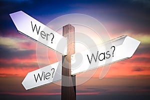 Wer? Was? Wie? - German, Who? What? How? - English - signpost with three arrows