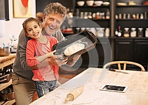 Were the best baking team ever. Portrait of a little girl and her grandfather baking together.