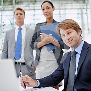 Were the best in the business. Portrait of a group of serious business executives in a boardroom.