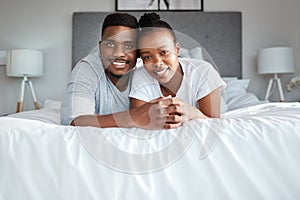 Were clinging to each other for life. Portrait of an affectionate young couple relaxing on their bed together at home.