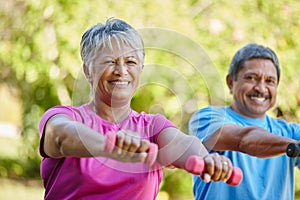 Were doing our best to stay active. Portrait of a mature couple exercising together in their backyard.