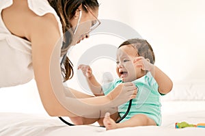 Were almost done, little one. Closeup shot of a paediatrician using a stethoscope during a babys checkup.