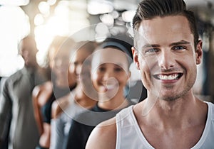 Were in this fitness game together. a group of young people standing together in a line at the gym.