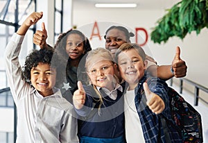 Were getting the best education at this school. a diverse group of children standing together in the hallway at school