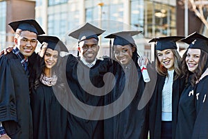 Were going to keep on succeeding throughout life. Portrait of a group of students standing together on graduation day.