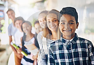 Were on a journey of learning together. Portrait of a group of happy schoolchildren standing in a line outside their