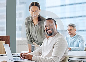 Were making great progress in our plans. Portrait of two businesspeople working together on a laptop in an office.