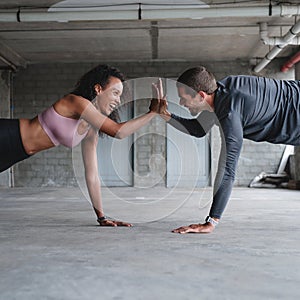 Were always motivating each other. a sporty young couple exercising together inside an underground parking lot.